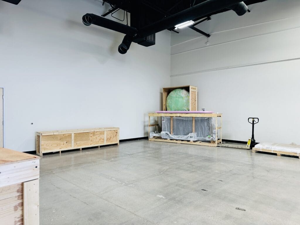 Custom wooden crates for secure transport of exhibit materials and artwork in a spacious Las Vegas warehouse.